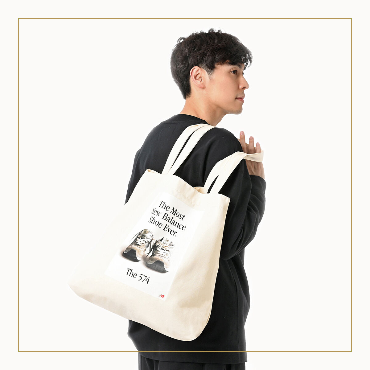 Man holding New Balance tote bag.